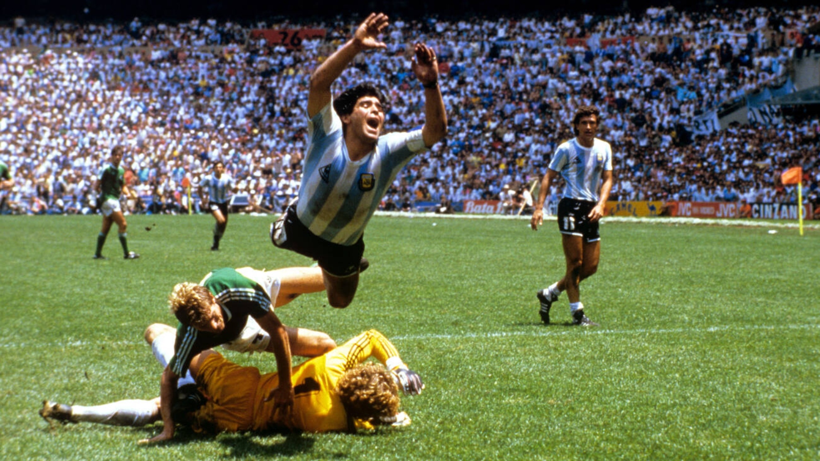 Soccer - World Cup Mexico 1986 - Final - Argentina v West Germany. Argentina's Diego Maradona (top) flies through the air after a challenge by West Germany goalkeeper Harald Schumacher (on floor)