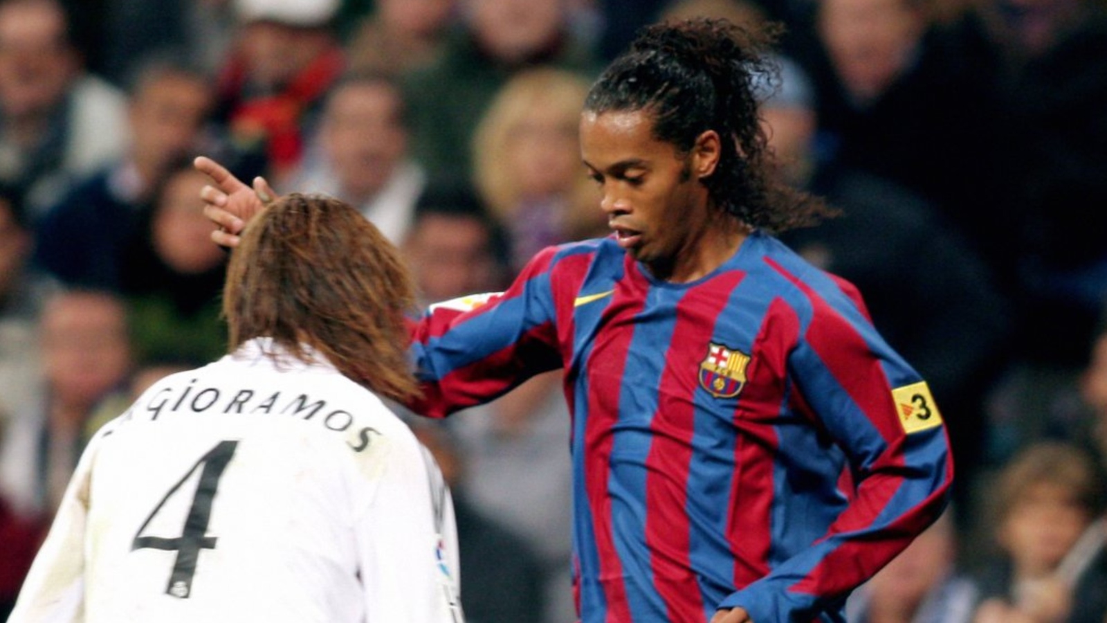 Barcelona's Ronaldinho takes on Real Madrid's Sergio Ramos.