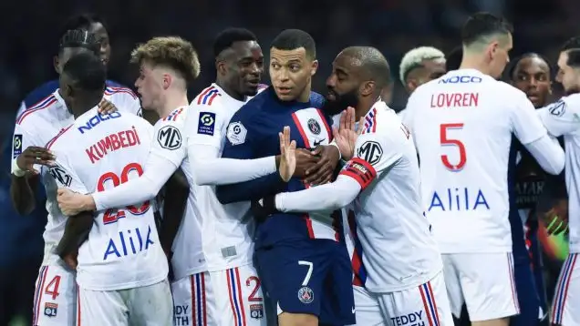 PSG's Kylian Mbappe, centre, argues with Lyon's players during the French League One soccer match between Paris Saint-Germain and Lyon at the Parc des Princes stadium in Paris, Sunday, April 2, 2023